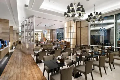 a dining room with tables and chairs and a restaurant at Grande Centre Point Hotel Terminal21 in Bangkok