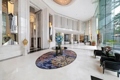 a lobby with a table in the middle of a building at Grande Centre Point Hotel Terminal21 in Bangkok