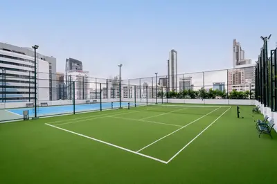 a tennis court in the middle of a city at Grande Centre Point Hotel Terminal21 in Bangkok