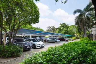 a group of cars parked in a parking lot at Lasalle Suites Hotel & Residence in Bangkok