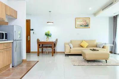 a living room with a couch and a table at Lasalle Suites Hotel & Residence in Bangkok