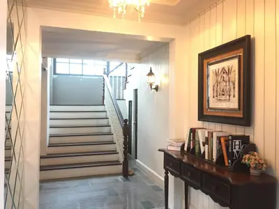 a hallway with a staircase with a picture on the wall at M. Swita เอ็ม.สวิต in Bangkok