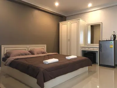 a bedroom with a bed with two towels on it at M. Swita เอ็ม.สวิต in Bangkok