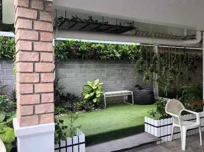 a garden with a bench and green grass at M. Swita เอ็ม.สวิต in Bangkok