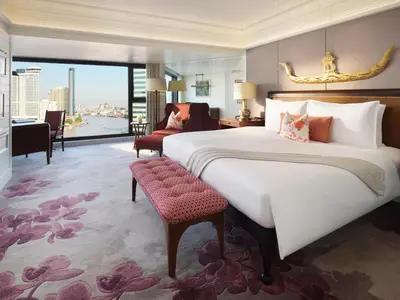 a bedroom with a large bed and a large window at Mandarin Oriental, Bangkok in Bangkok