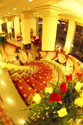 a banquet hall with a table with flowers on it at Ebina House - SHA Extra Plus in Bangkok