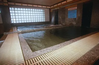 a swimming pool in a building with water in it at Ebina House - SHA Extra Plus in Bangkok