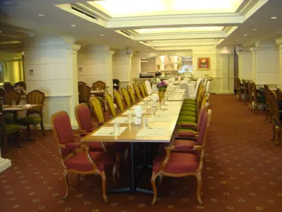 a dining room with a long table and chairs at Ebina House - SHA Extra Plus in Bangkok