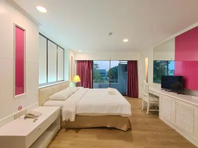 a bedroom with a bed and a desk and a television at Ebina House - SHA Extra Plus in Bangkok