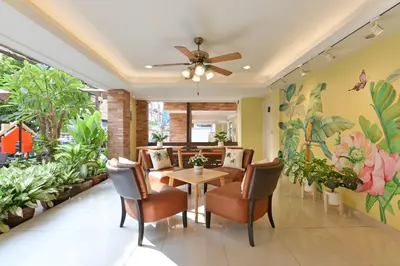 a dining room with a table and chairs and plants at Salin Home Hotel Ramkhamhaeng in Bangkok