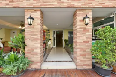 a brick entry way with plants in pots at Salin Home Hotel Ramkhamhaeng in Bangkok