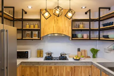 a kitchen with wooden cabinets and a counter top at Timber Hostel in Bangkok