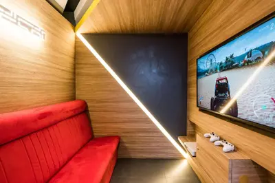 a room with a red bench and a flat screen tv at Vib Best Western Sanam Pao in Bangkok