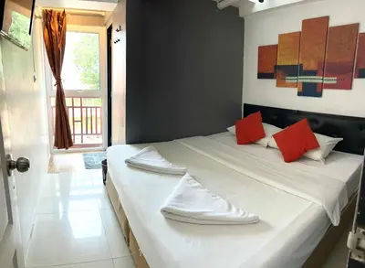 a bedroom with a large white bed with red pillows at Happio Near Chabad House in Bangkok