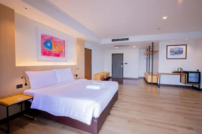a hotel room with a large bed and a television at The Royal River Hotel in Bangkok