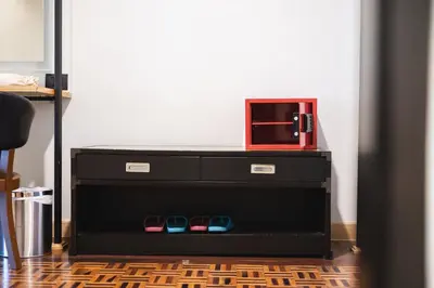 a microwave sitting on top of a dresser at The Royal River Hotel in Bangkok