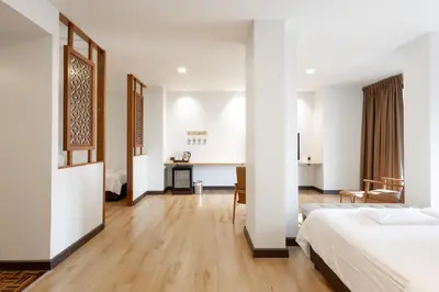 a hotel room with a bed and a desk at The Royal River Hotel in Bangkok