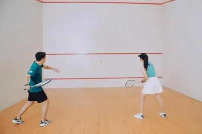 a man and a woman playing a game of tennis at SC Park Hotel in Bangkok