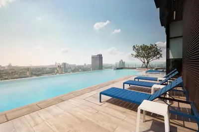 a swimming pool on the roof of a building at The Quarter Ari by UHG in Bangkok