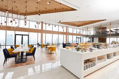a restaurant with tables and chairs and a buffet at The Quarter Ari by UHG in Bangkok