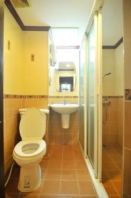 a bathroom with a toilet and a sink at Malaysia Hotel Bangkok in Bangkok