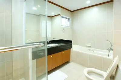 a bathroom with a toilet and a sink at Chaidee Mansion in Bangkok