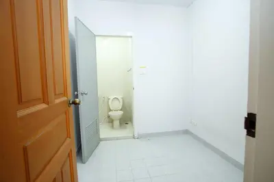 a bathroom with a toilet in a stall at Chaidee Mansion in Bangkok
