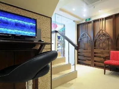 a living room with a flat screen tv and a couch at Royal Express Inn in Bangkok