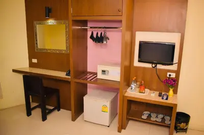 a room with a desk with a computer and a tv at Royal Express Inn in Bangkok