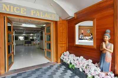 a nice palace building with a statue of a woman at Nice Palace Hotel in Bangkok
