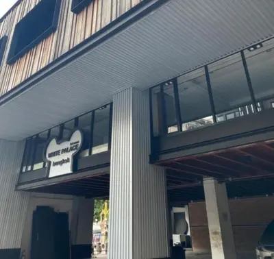 a building with a sign on the side of it at White Palace Bangkok in Bangkok