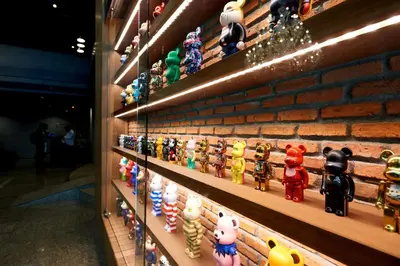 a display of toys on a brick wall at White Palace Bangkok in Bangkok