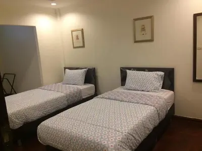 a room with two beds with pillows on them at Nineplace 46 in Bangkok
