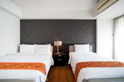 two beds sitting next to each other in a room at Lily Hotel Bangkok in Bangkok