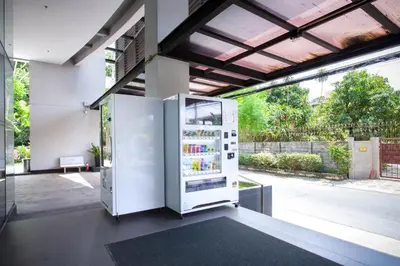a large white refrigerator sitting inside of a building at Lily Hotel Bangkok in Bangkok