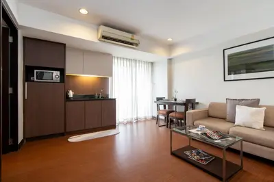 a living room with a couch and a table at Lily Hotel Bangkok in Bangkok