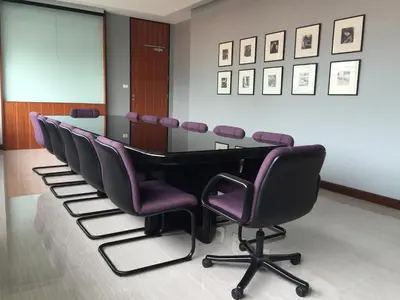 a conference room with a table and purple chairs at Indra Regent Hotel in Bangkok