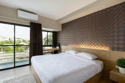 a bedroom with a white bed and a large window at @S115 Residence in Samutprakarn