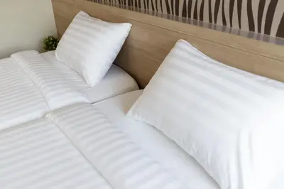 two white pillows sitting on top of a bed at @S115 Residence in Samutprakarn