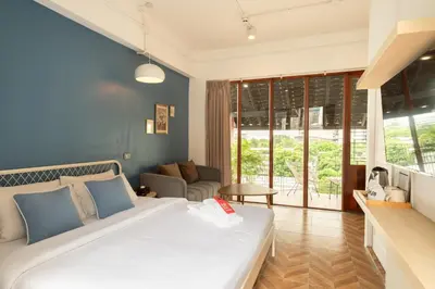 a bedroom with a bed and a living room at House Of PaPa Bangkok Siam in Bangkok