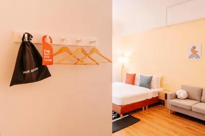 a room with a bed and a black bag hanging on a wall at House Of PaPa Bangkok Siam in Bangkok