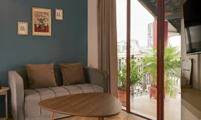 a living room with a couch and a table at House Of PaPa Bangkok Siam in Bangkok