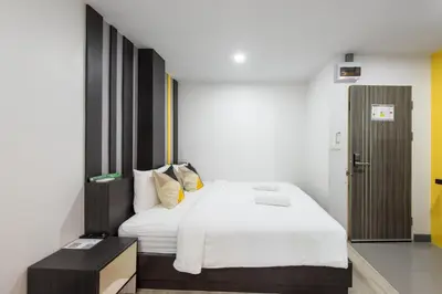 a bedroom with a large bed with white sheets at Riski Residence Bangbuathong in Nonthaburi
