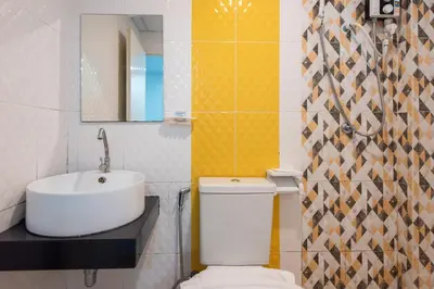a bathroom with a white toilet and a sink at Riski Residence Bangbuathong in Nonthaburi