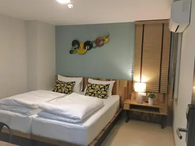 a bedroom with a bed with white sheets and pillows at Bangkok Saran Poshtel in Bangkok