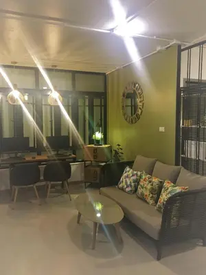 a living room with a couch and a table at Bangkok Saran Poshtel in Bangkok