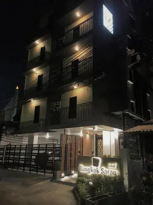 a building with a sign in front of it at night at Bangkok Saran Poshtel in Bangkok