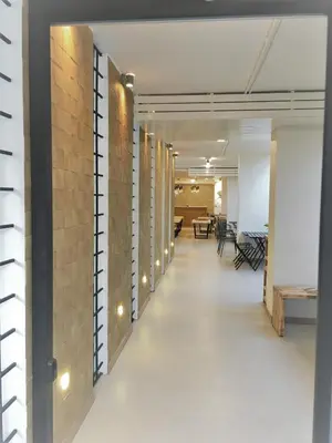 an office corridor with a brick wall with lights at Bangkok Saran Poshtel in Bangkok