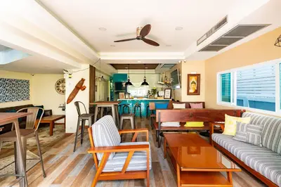 a restaurant with tables and chairs and a bar at Maneeya Park Residence in Bangkok