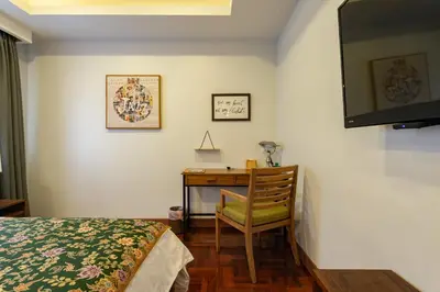 a bedroom with a desk and a bed and a chair at Maneeya Park Residence in Bangkok